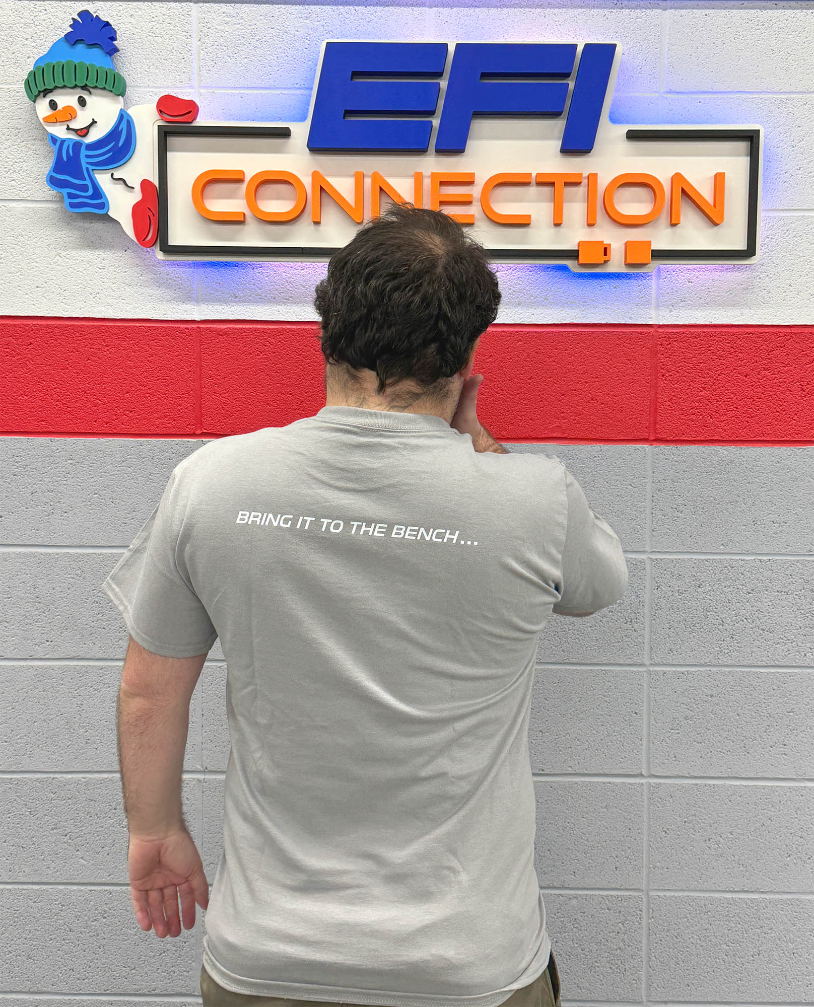 Back of a T-Shirt that says "bring it to the bench..."